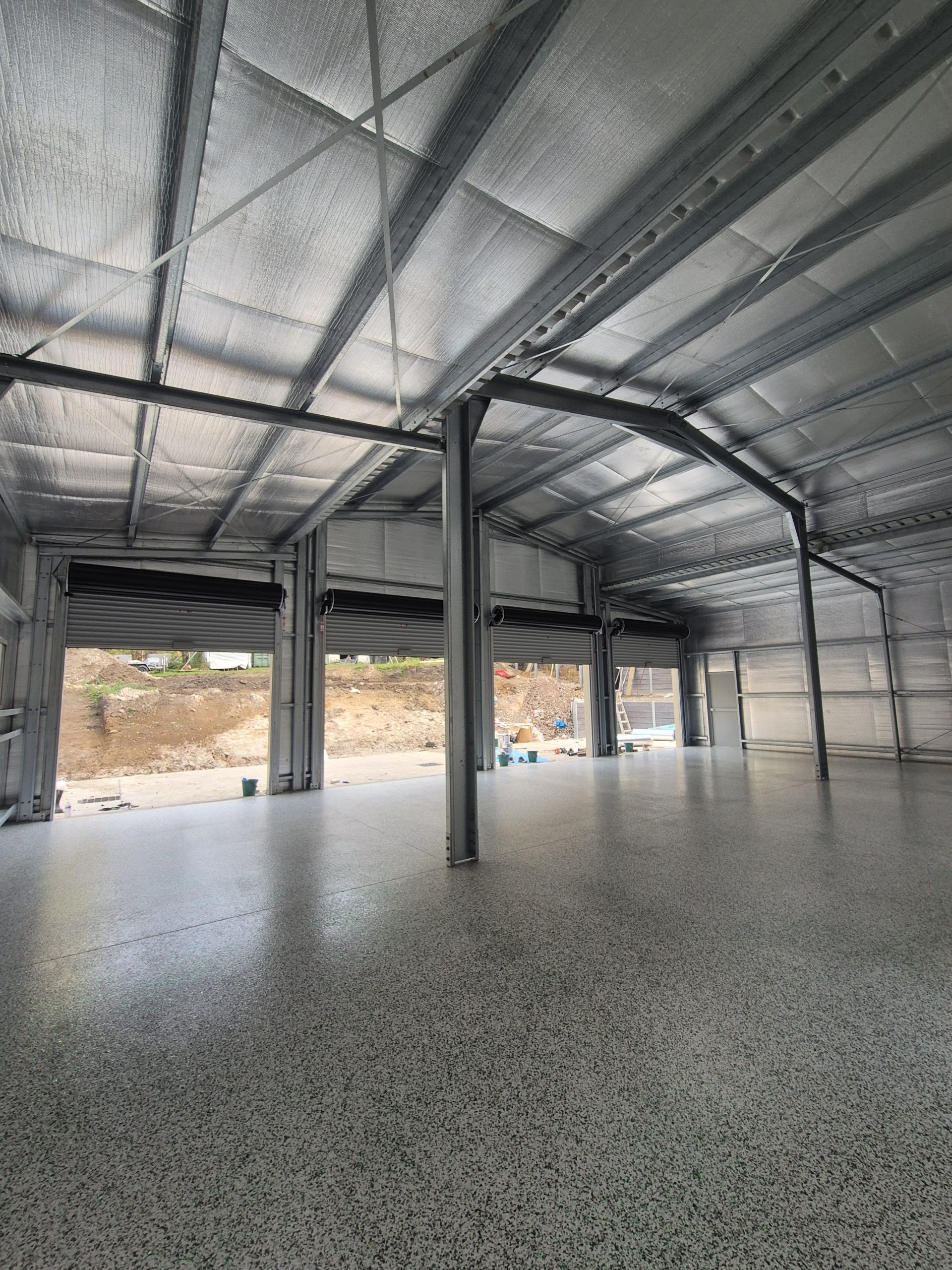 150m2 industrial shed floor with green & white flake epoxy finish in Ulladulla by ProSand."
