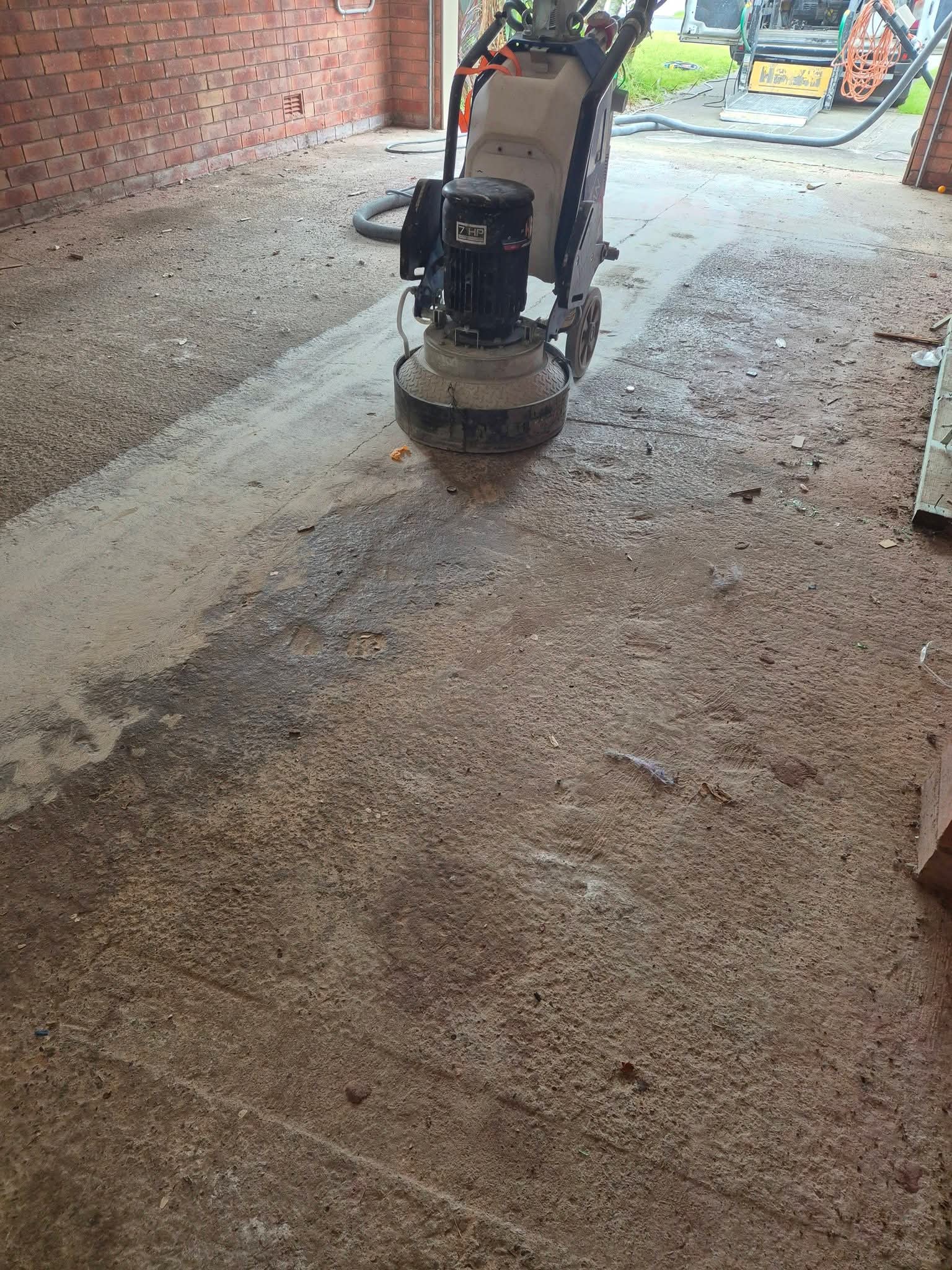 Close-up of diamond grinding concrete floor preparation in an Ulladulla workshop.