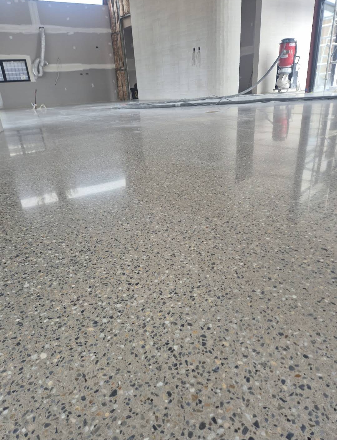 Matte satin 400 grit mechanically polished concrete indoor floor for a coastal residential property in Culburra Beach.